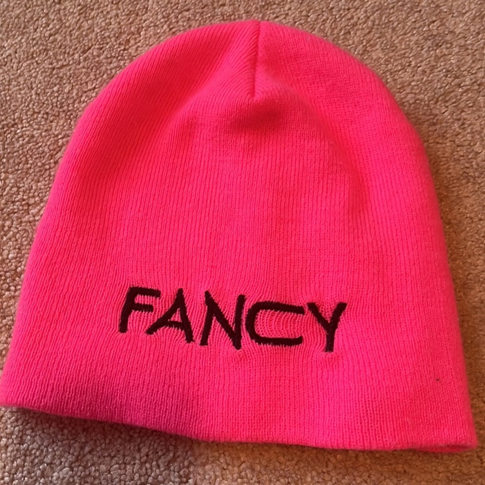 Hi! This is a hot pink hat with the words fancy in black bold. Great Condition!